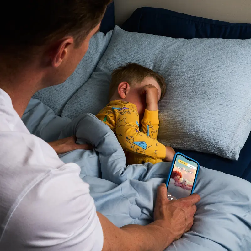 Parent and child reading together at bedtime